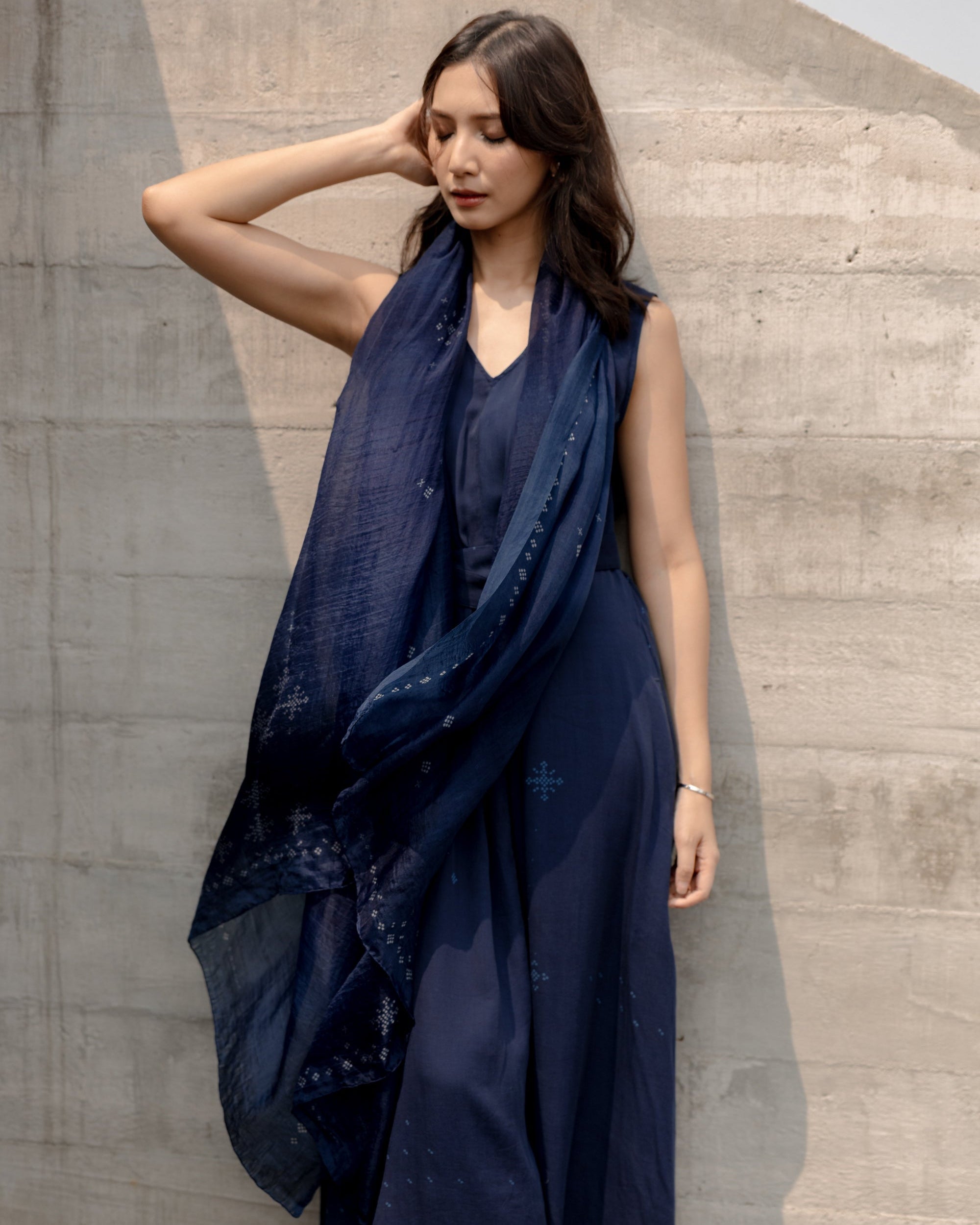 Sheila Dara wearing a dark SukkhaCitta Indigo dress with an exclusive Angkasa scarf from SORE The Movie.